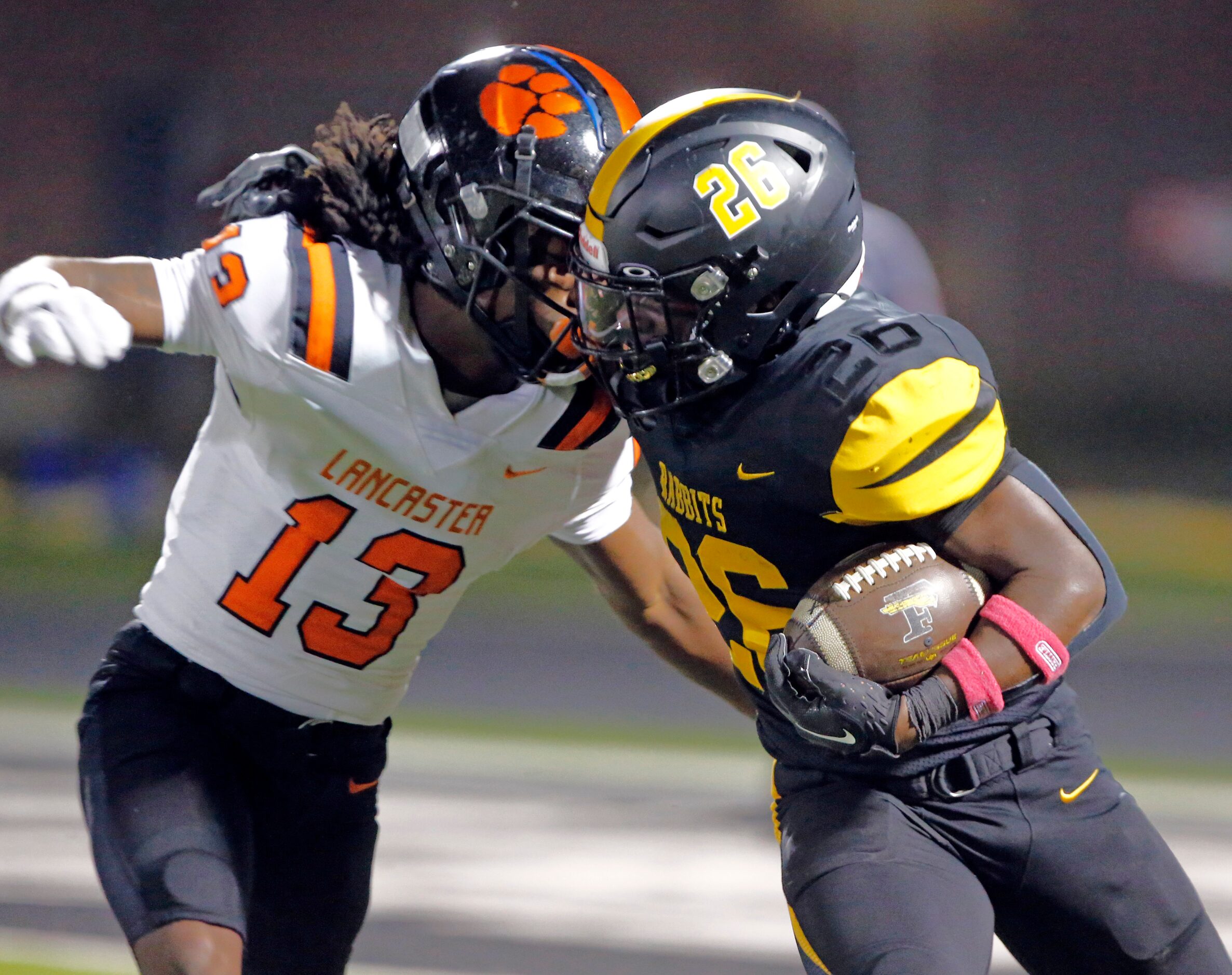 Forney high’s Javian Osborne (26) battles around Lancaster high’s Jerbrandin Henderson (13)...