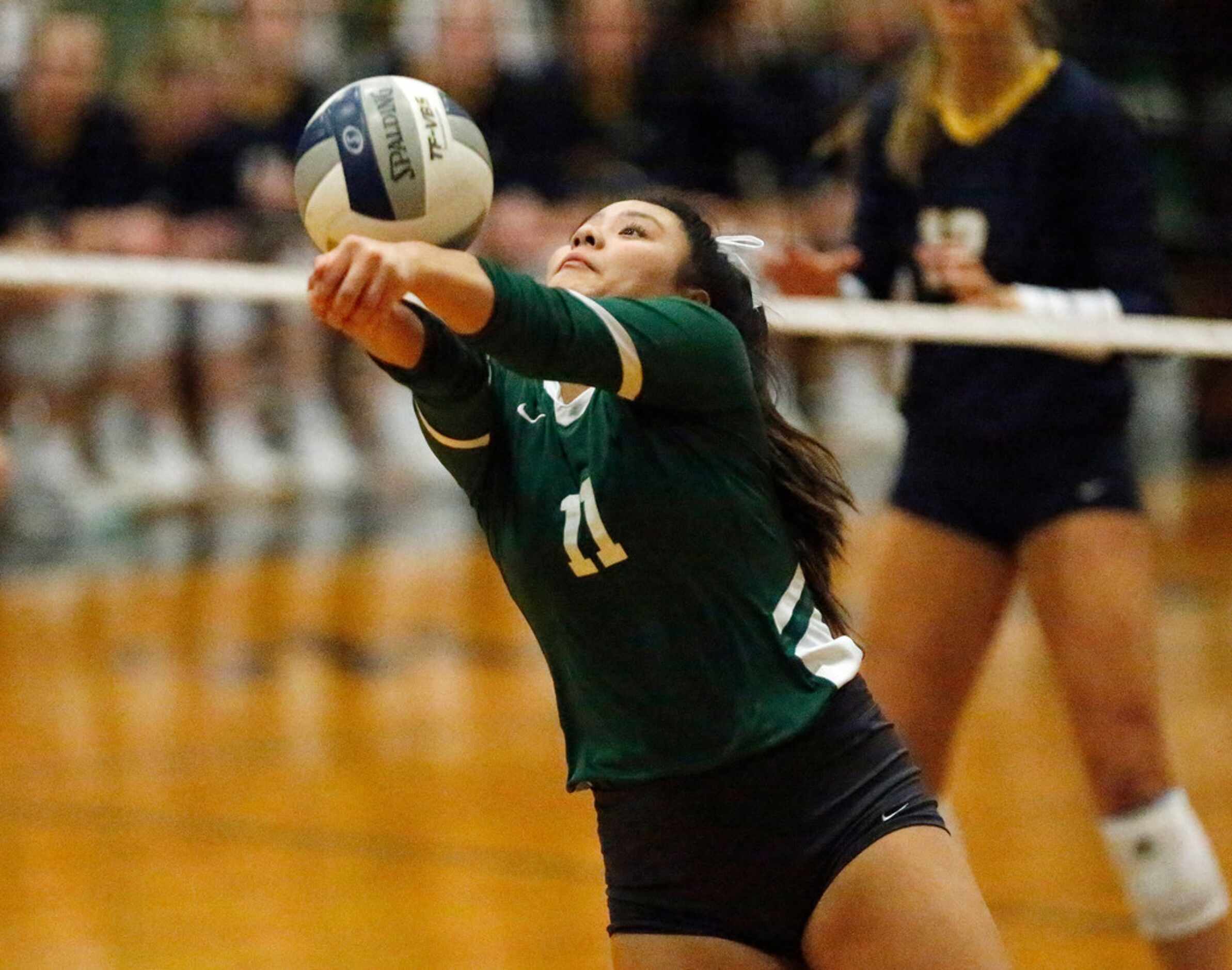Lebanon Trail High School setter Xuan Nguyen (11) keeps the ball in play during game three...