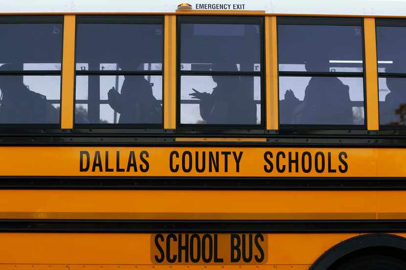 A bus prepares to drop students off at W.E. Greiner Exploratory Arts Academy in Dallas on...