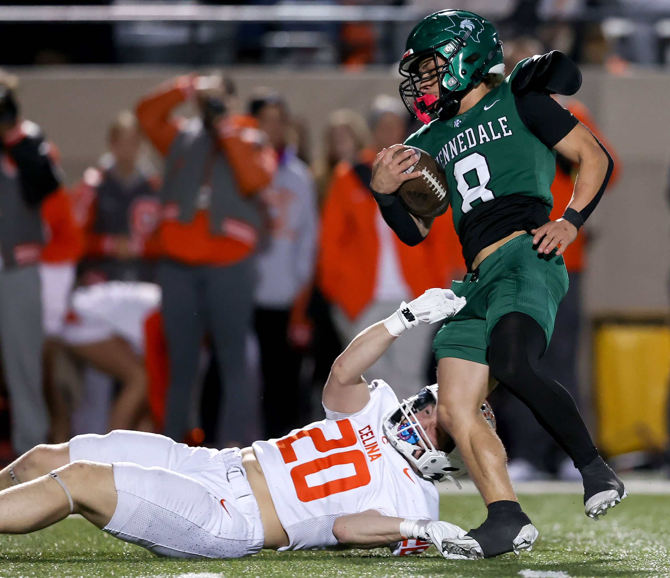 Kennedale kick returner Riley Bingham (8) is dragged down by Celina's Conner Bergman (20)...