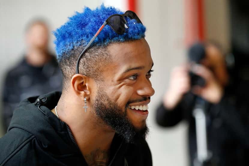 Texas Rangers outfielder Delino DeShields sports blue hair before dropping a Spring Training...