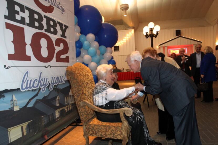 Associate Dick Clements greets Ebby Halliday as she celebrates her 102nd birthday at a...