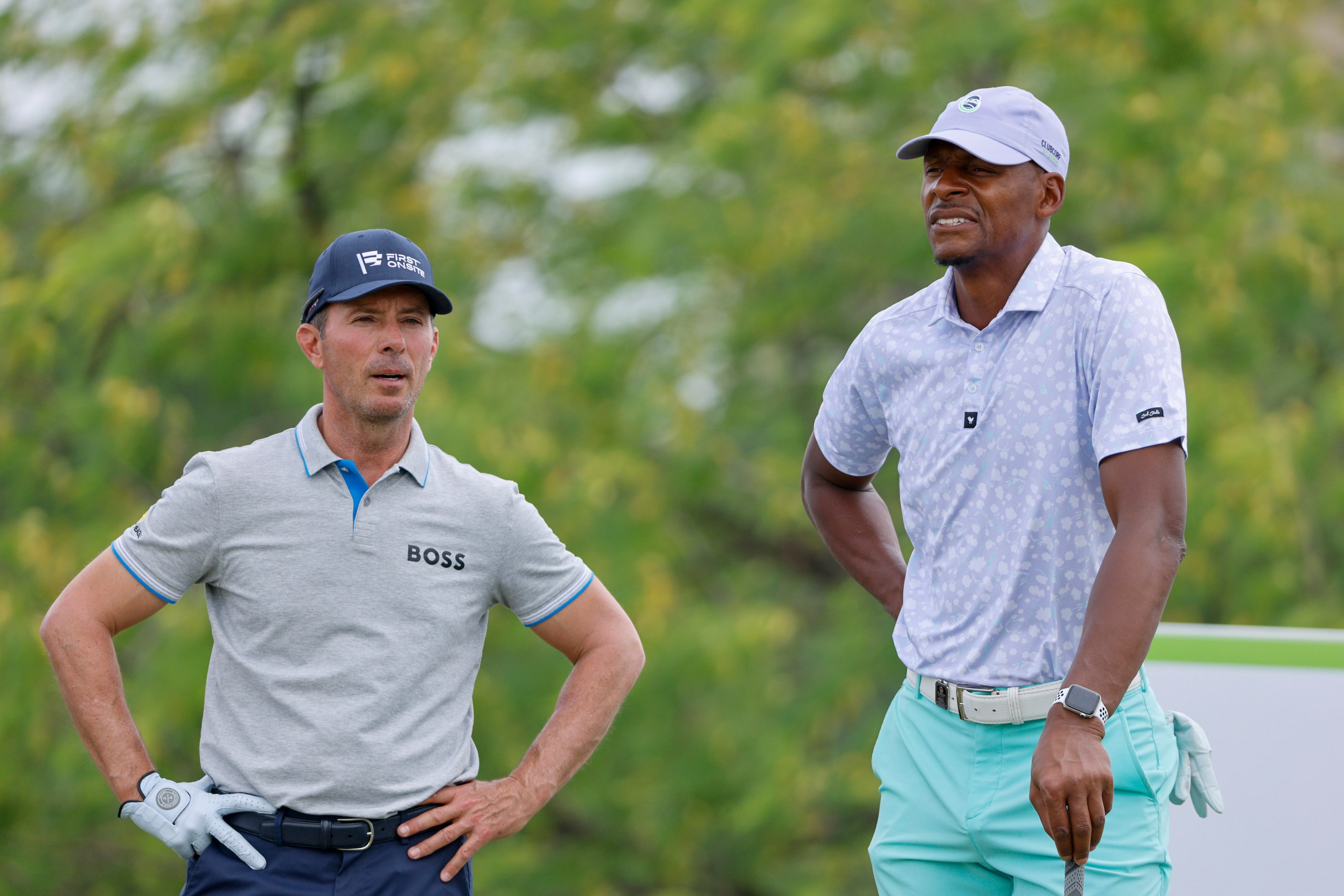 Former NBA basketball player Ray Allen (right) listens to professional golfer Mike Weir...