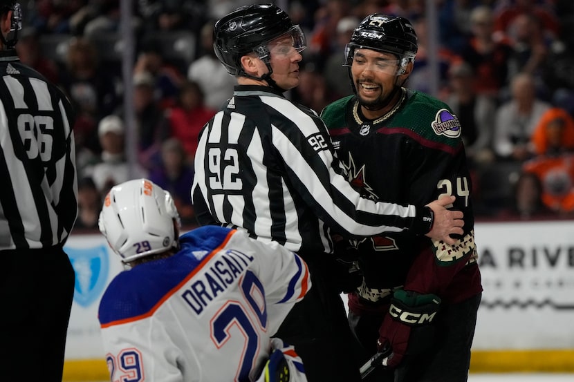 Arizona Coyotes defenseman Matt Dumba (24) has words with Edmonton Oilers center Leon...