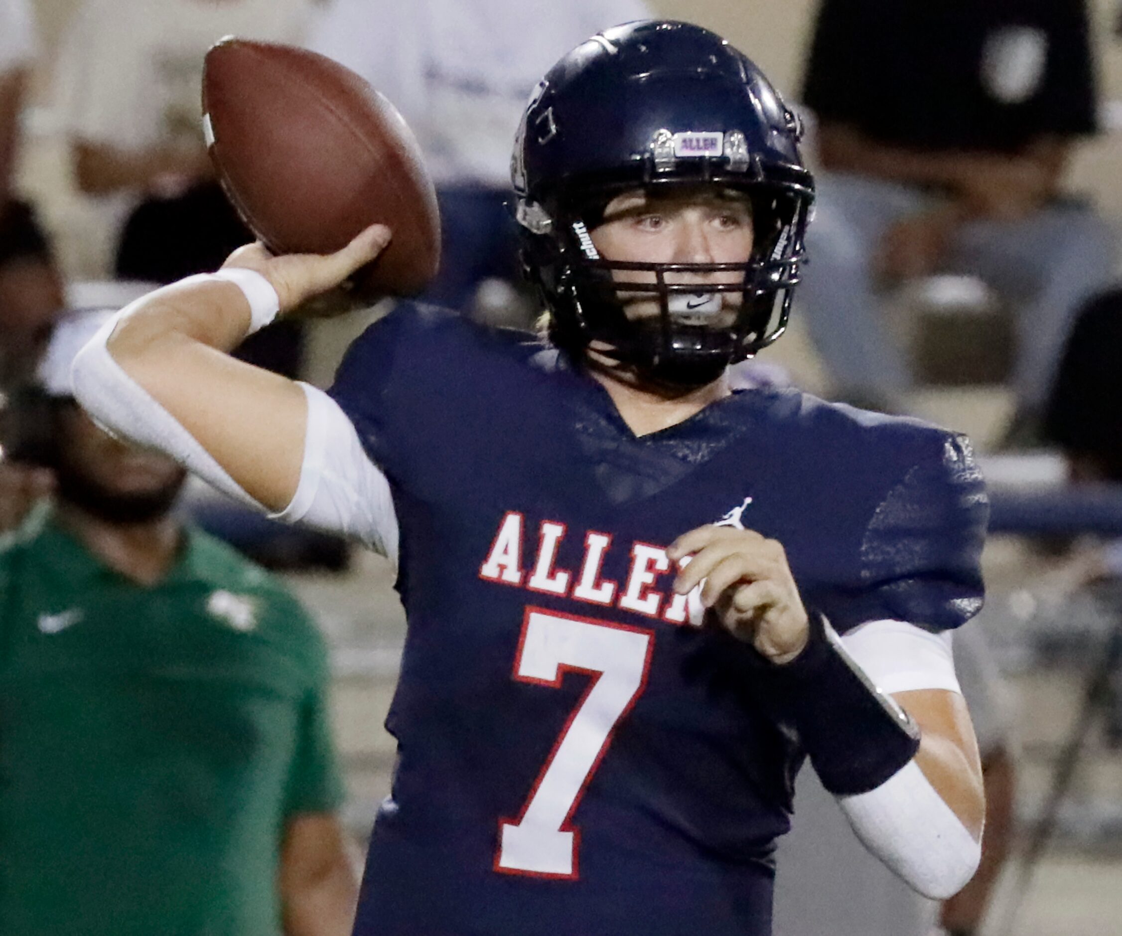 Allen High School quarterback Brady Bricker (7) attempts a pass during the first half as...