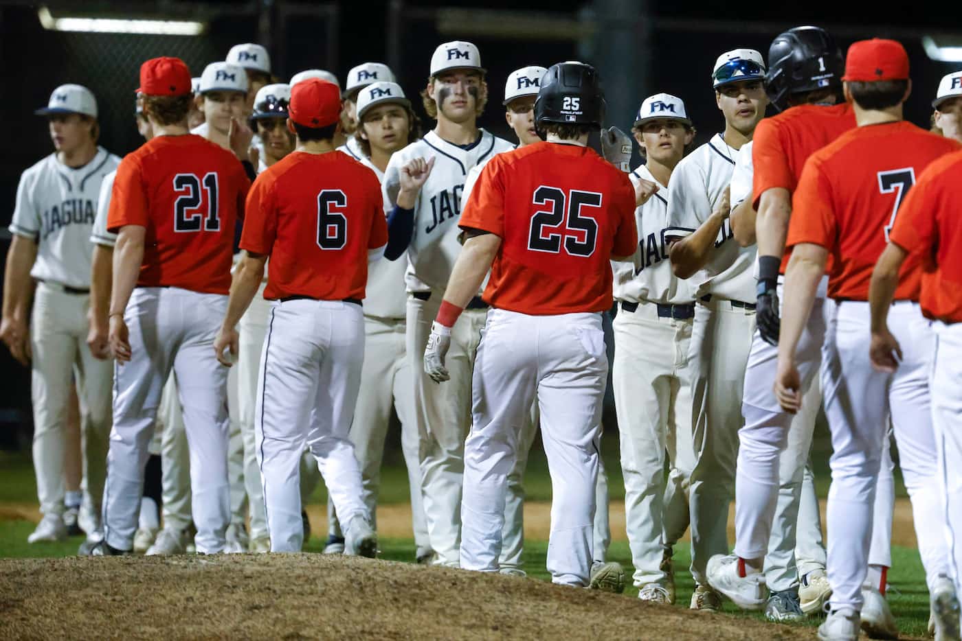 Flower Mound and Coppell high players shake hands after a baseball game at Flower Mound High...
