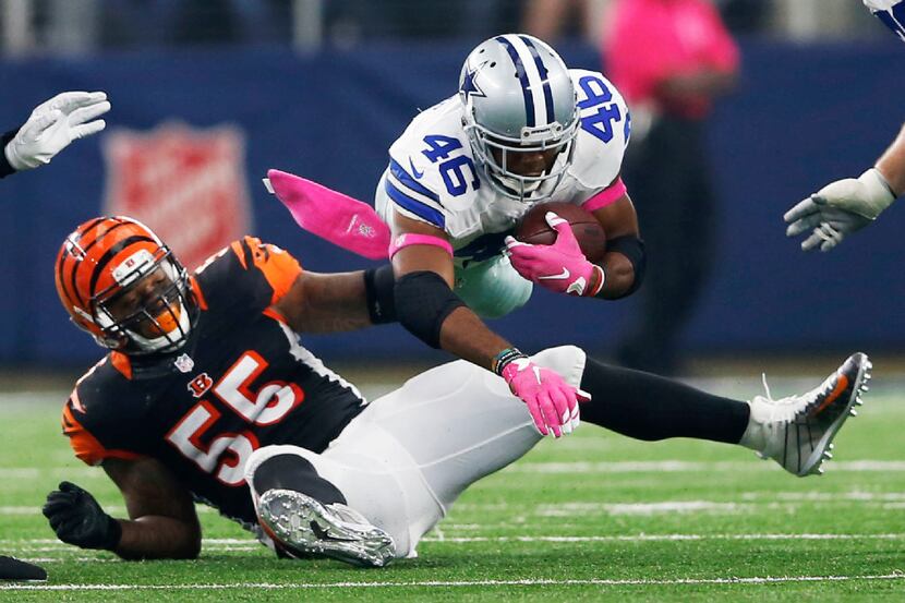 Dallas Cowboys running back Alfred Morris (46) is tripped up by Cincinnati Bengals outside...