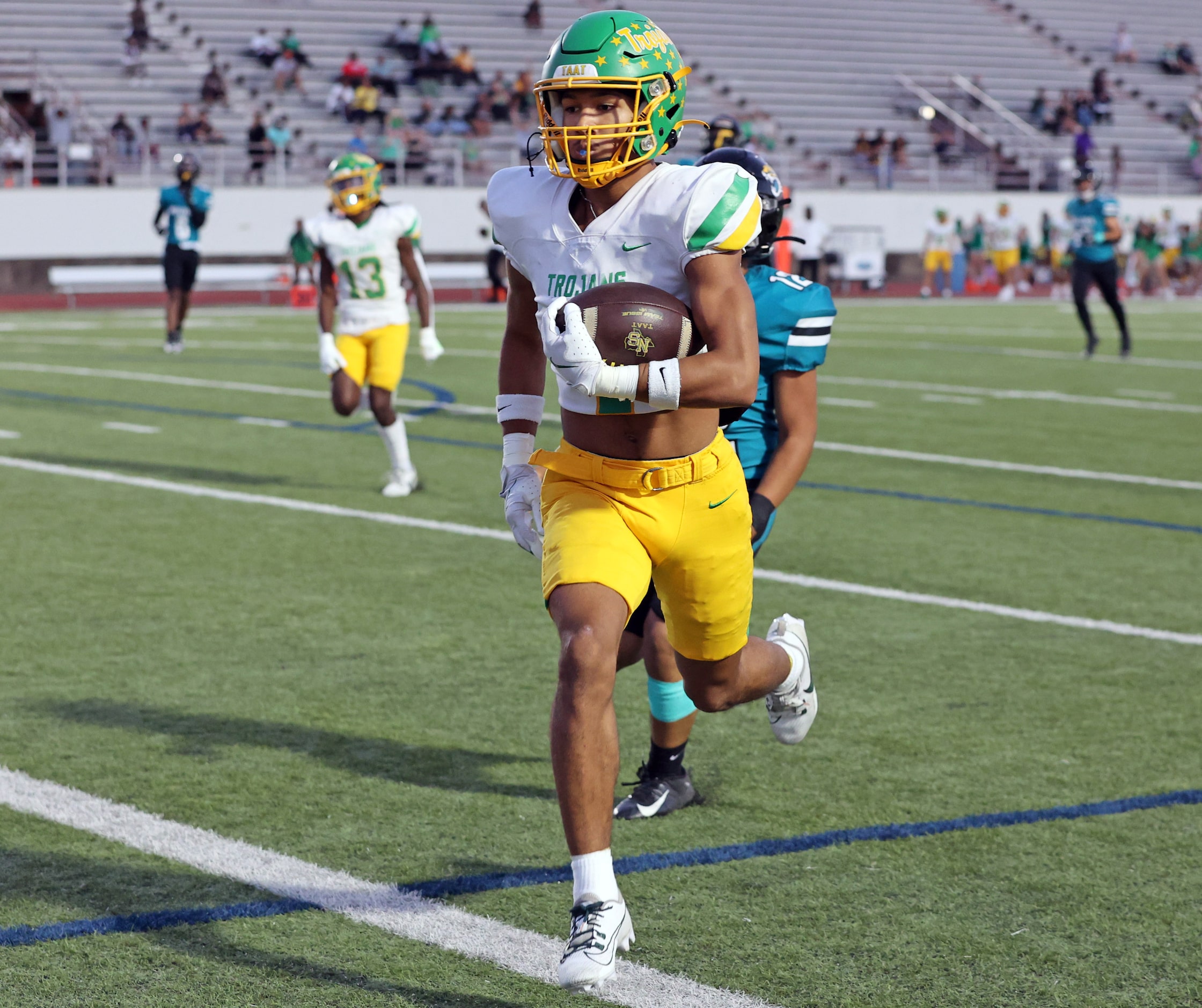 Carrollton Newman Smith high’s Maxim Mingo (4) heads to the end zone for a touchdown during...