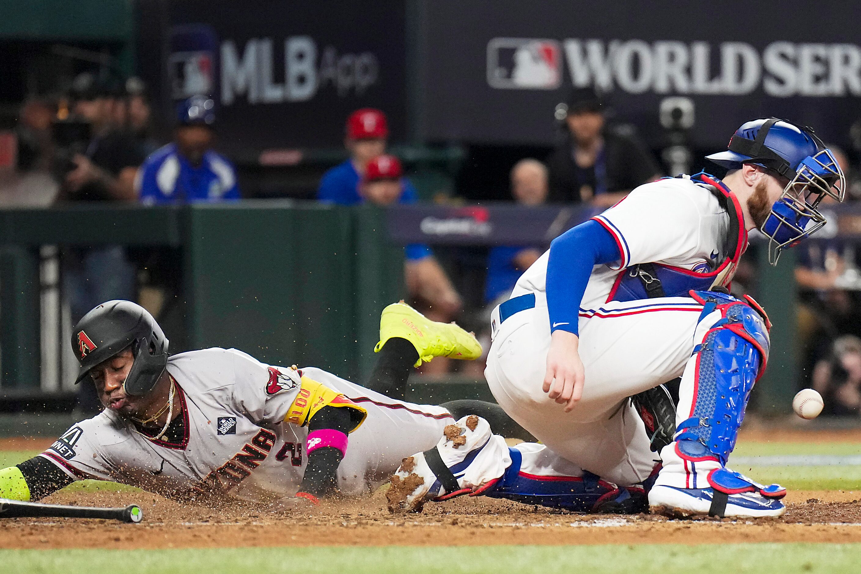 Arizona Diamondbacks' Geraldo Perdomo scores behind Texas Rangers catcher Jonah Heim on a...