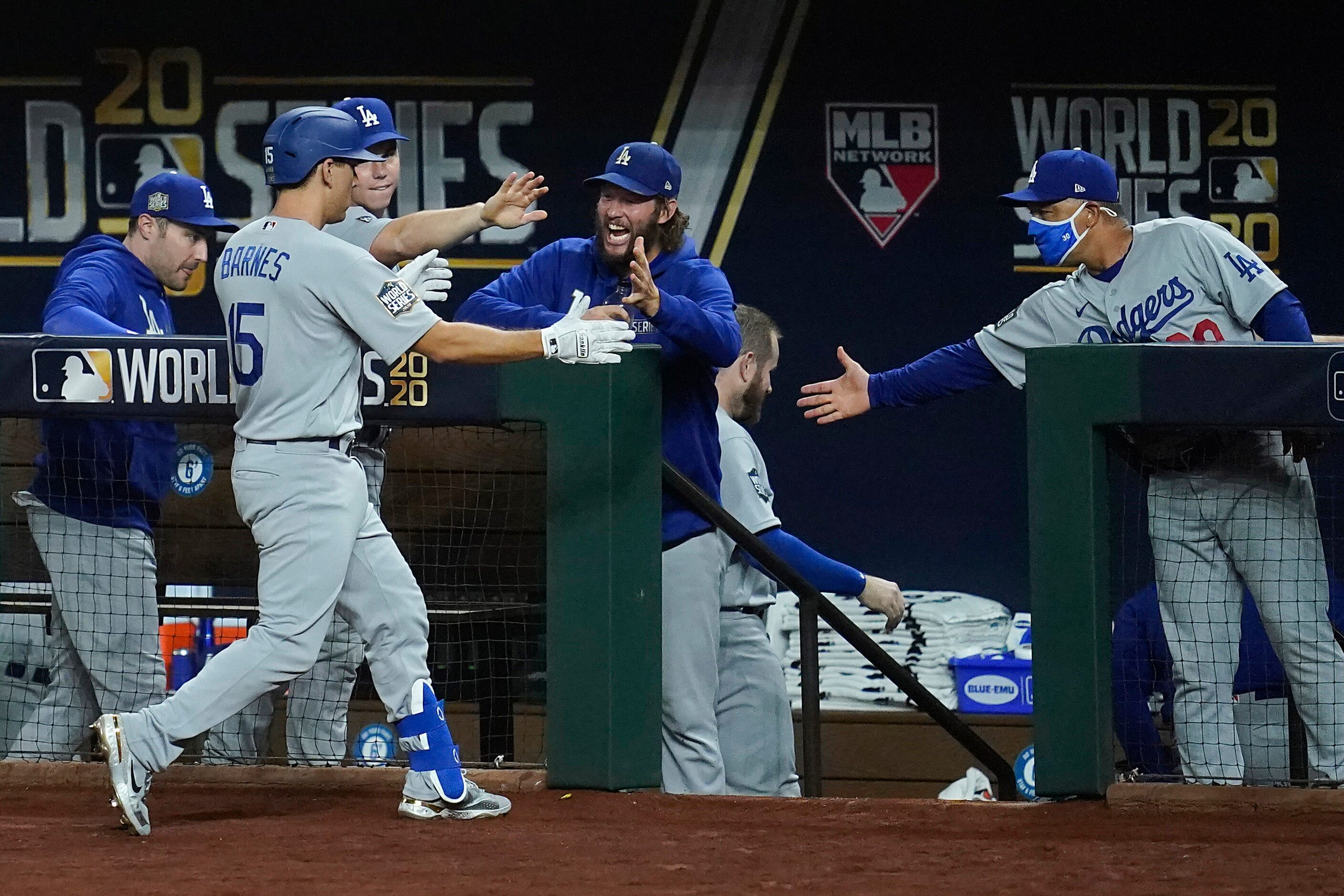 Los Angeles Dodgers catcher Austin Barnes (15) gets a hand from starting pitcher Clayton...