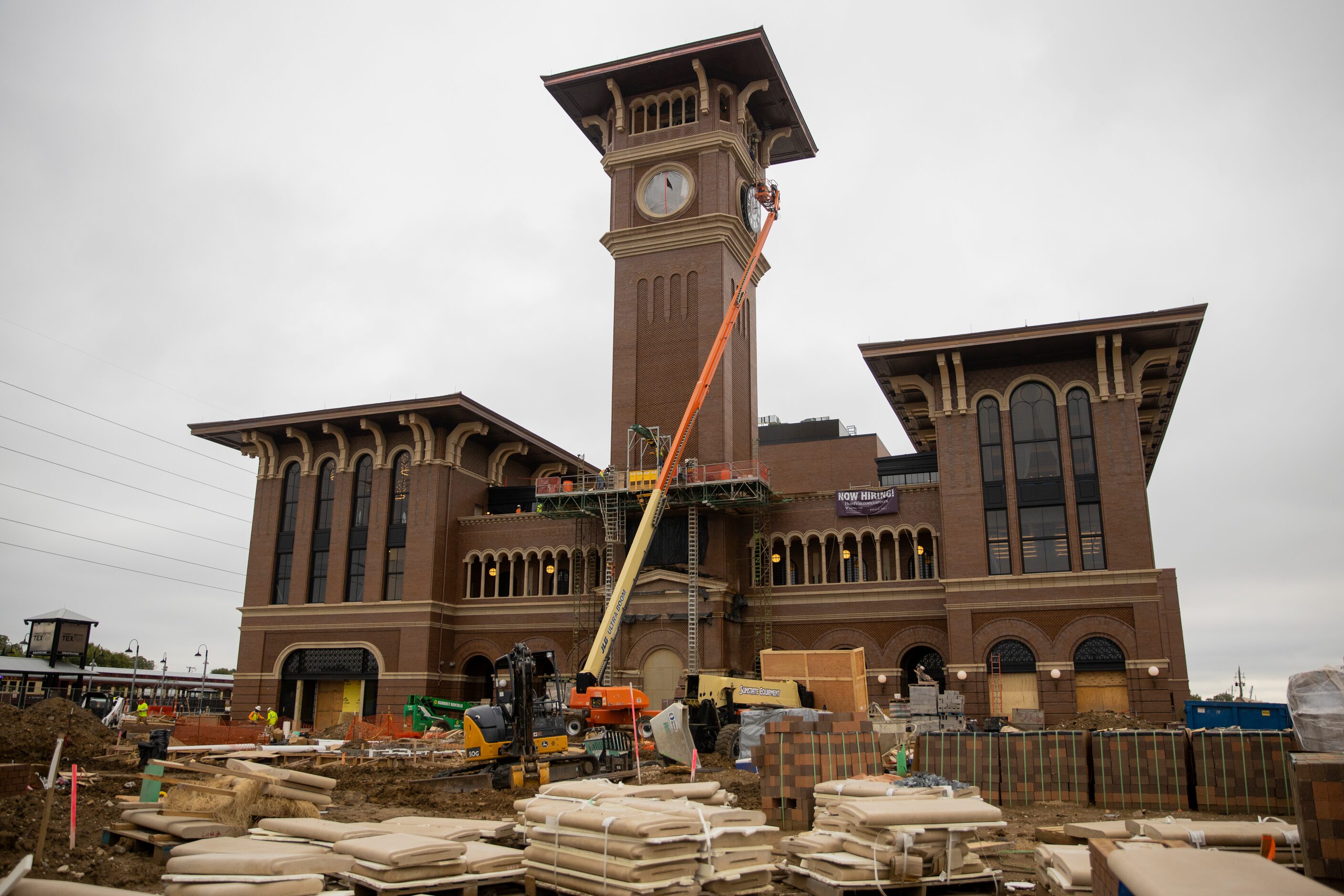 A crew from MEI Rigging & Crating works to install a 12-foot glass clock on the Grapevine...