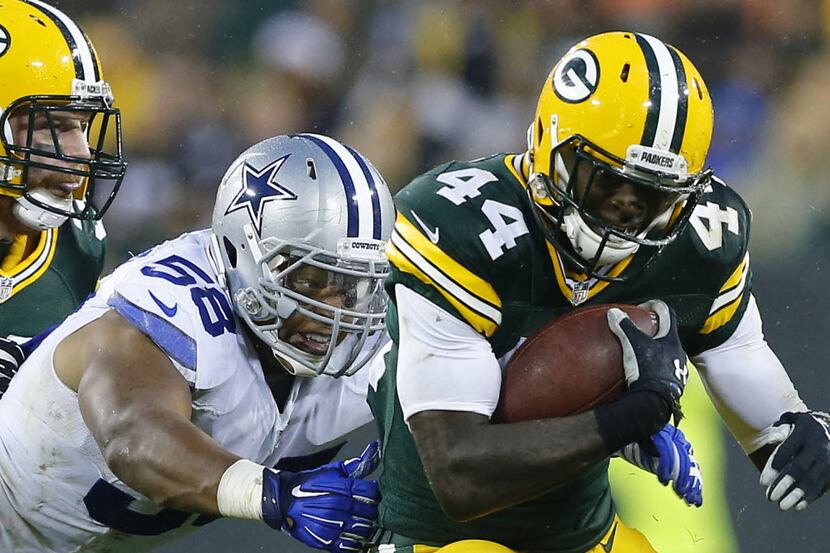 Dallas Cowboys defensive end Jack Crawford (58) reaches for Green Bay Packers running back...
