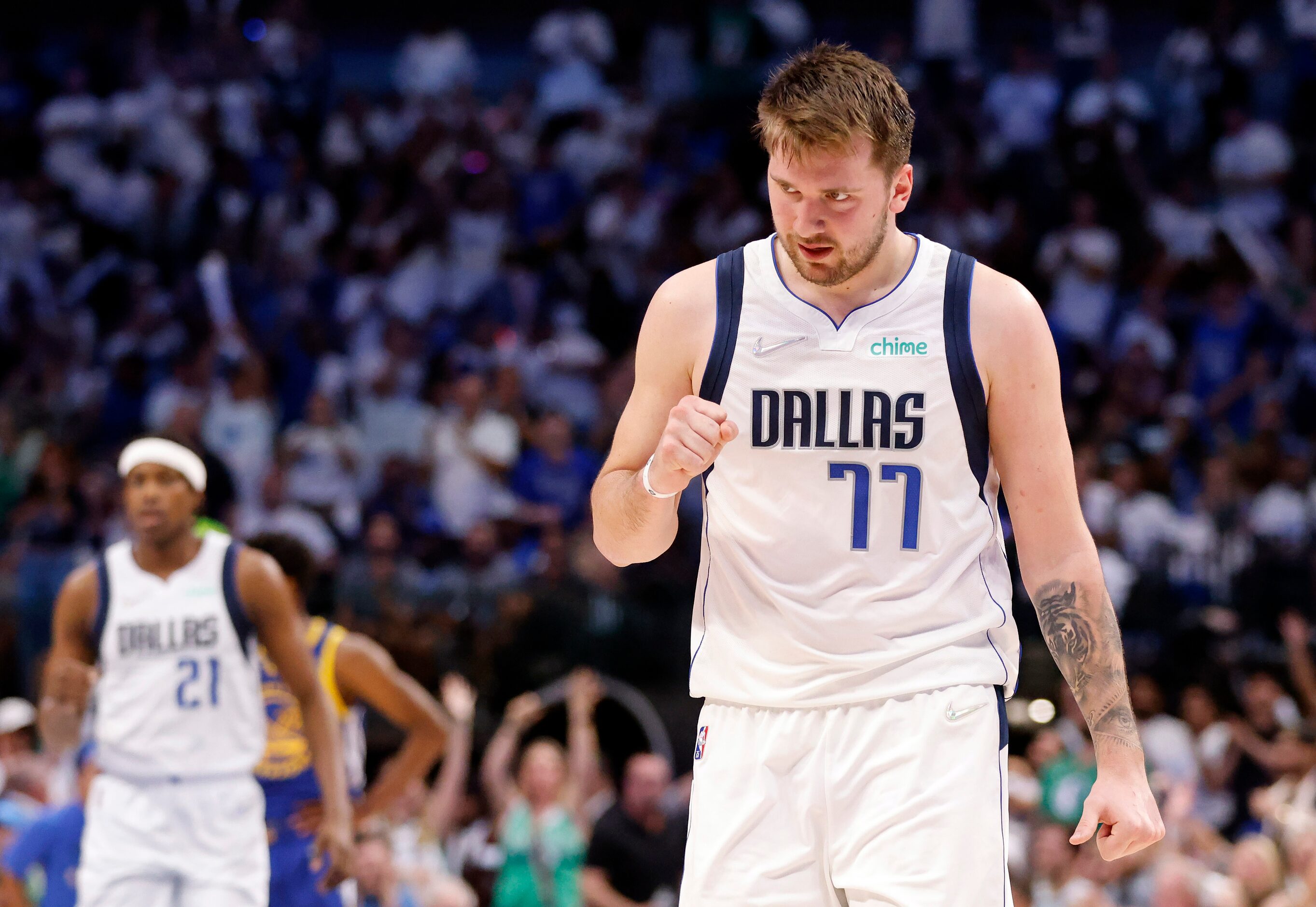 Dallas Mavericks guard Luka Doncic (77) pumps his fist as he comes to the bench after the...