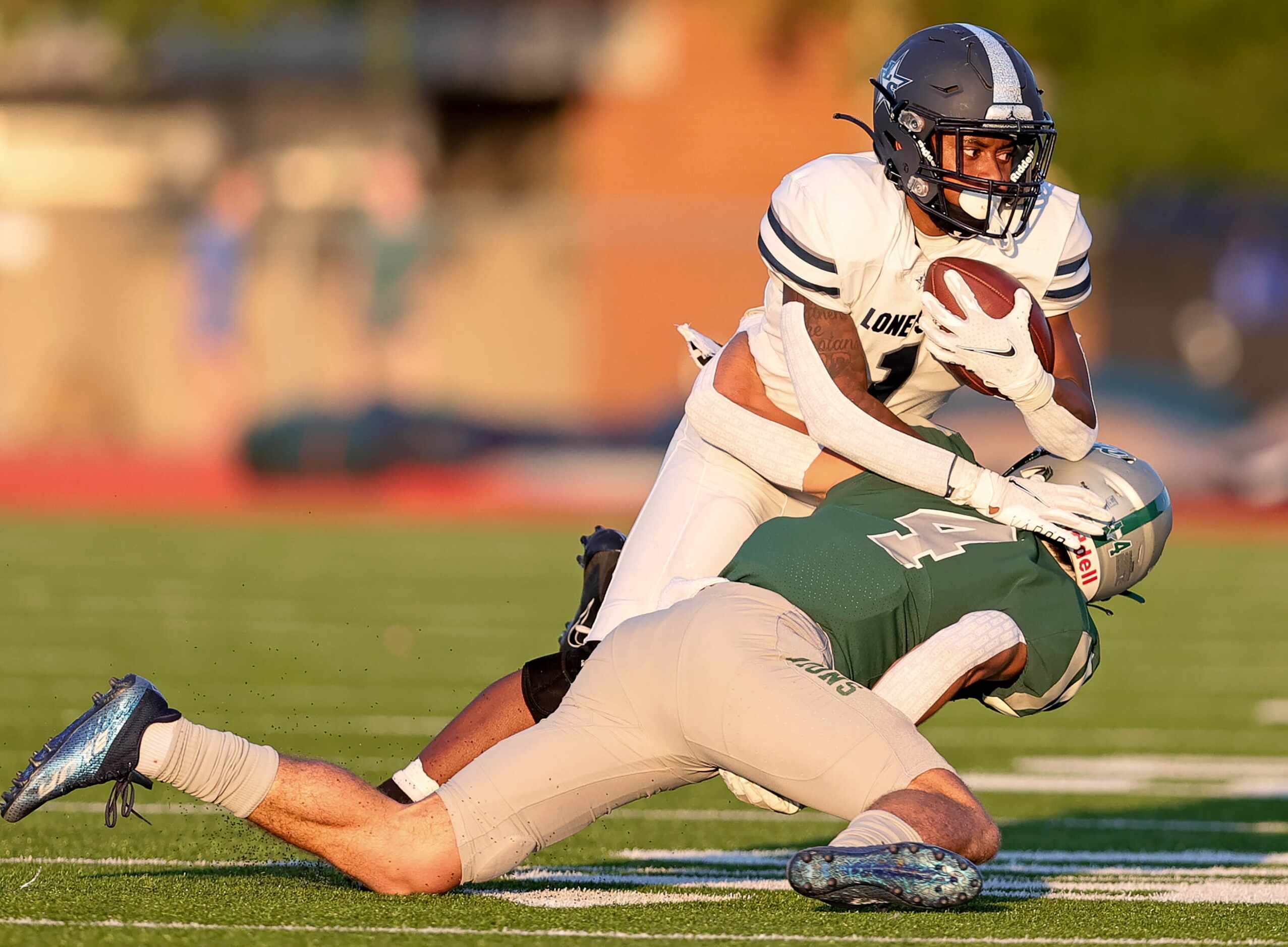 Frisco Lone Star running back Gerald Harris (1) gets stopped for a loss by Frisco Reedy...
