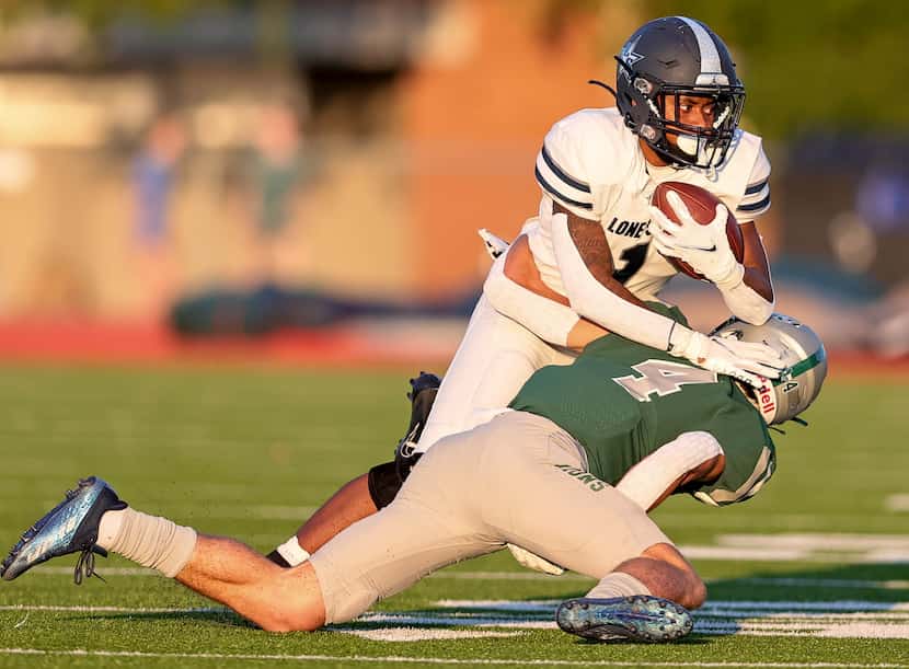 Frisco Lone Star running back Gerald Harris (1) gets stopped for a loss by Frisco Reedy...