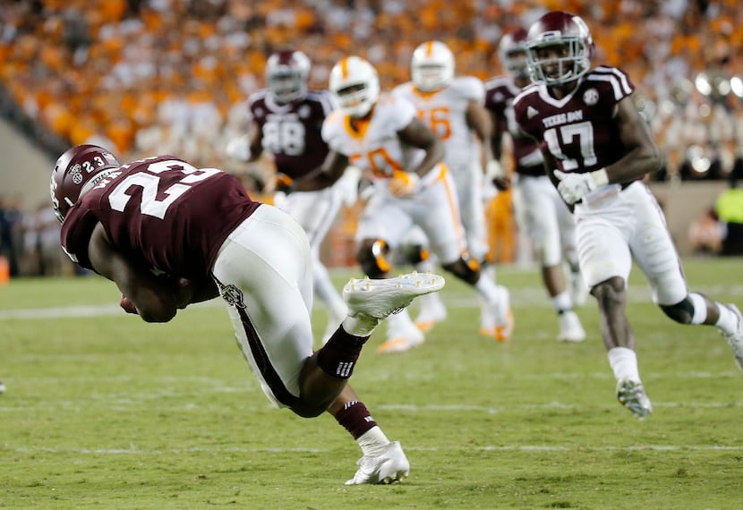 Texas A&M defensive back Armani Watts (23) intercepts a Tennessee pass to seal a 45-38...