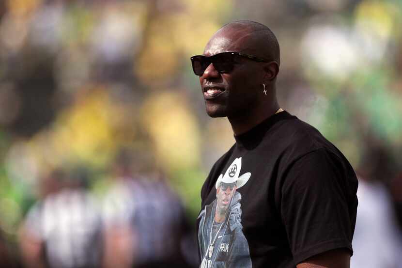 Former NFL football player Terrell Owens looks on during warm ups before an NCAA football...