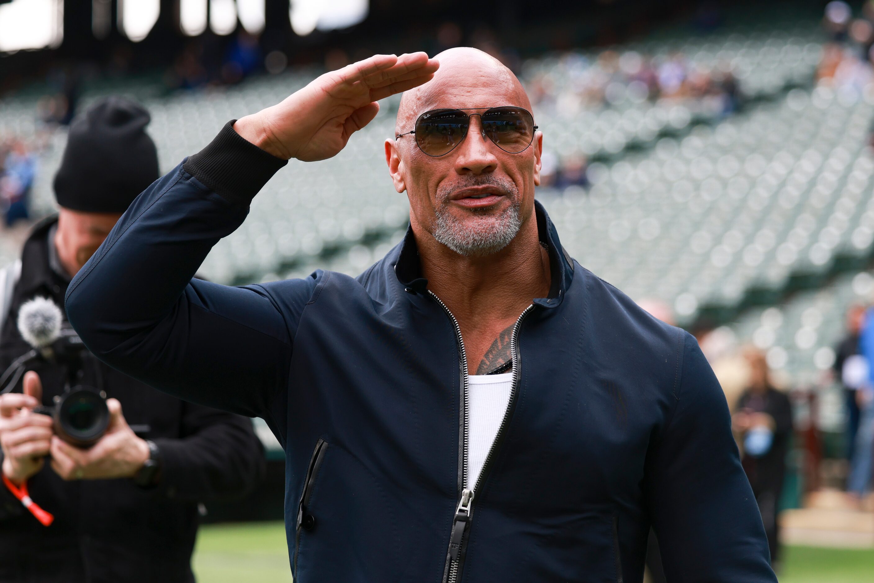 Dwayne “The Rock” Johnson salutes to the crowd before an XFL football game between the...