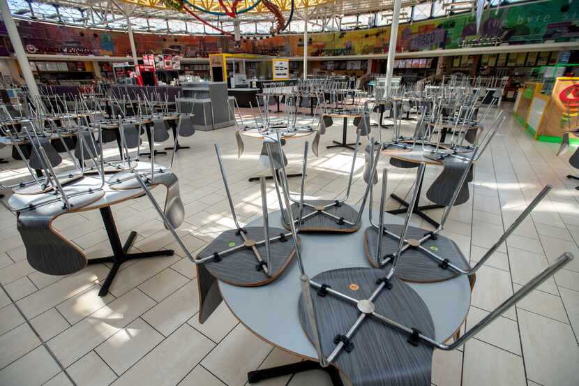 Chairs rest on tables around 1:30 p.m. in an empty food court in Stonebriar Mall on...