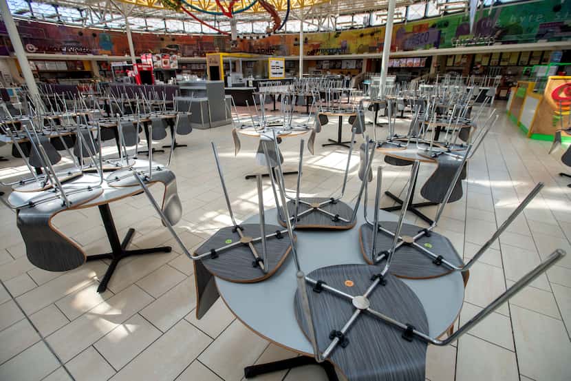 Chairs rest on tables around 1:30 p.m. in an empty food court in Stonebriar Mall on...