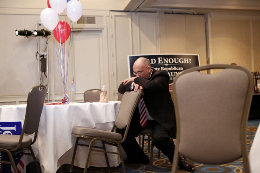 Craig Bass sits in disbelief after the announcement of President Barack Obama's re-election...