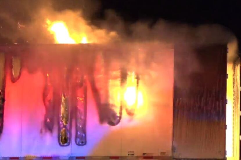 The cargo compartment of an 18-wheeler burns after catching fire on Interstate 20 in Terrell...