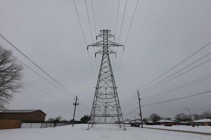 A transmission tower supports power lines after a snow storm on Feb. 17, 2021 in Altamesa...