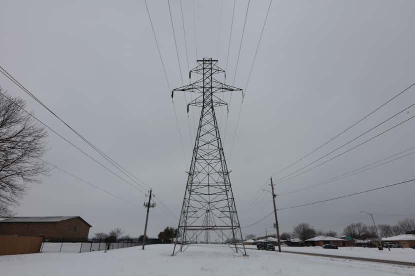 A transmission tower supports power lines after a snowstorm on Feb. 17, 2021 in Altamesa...