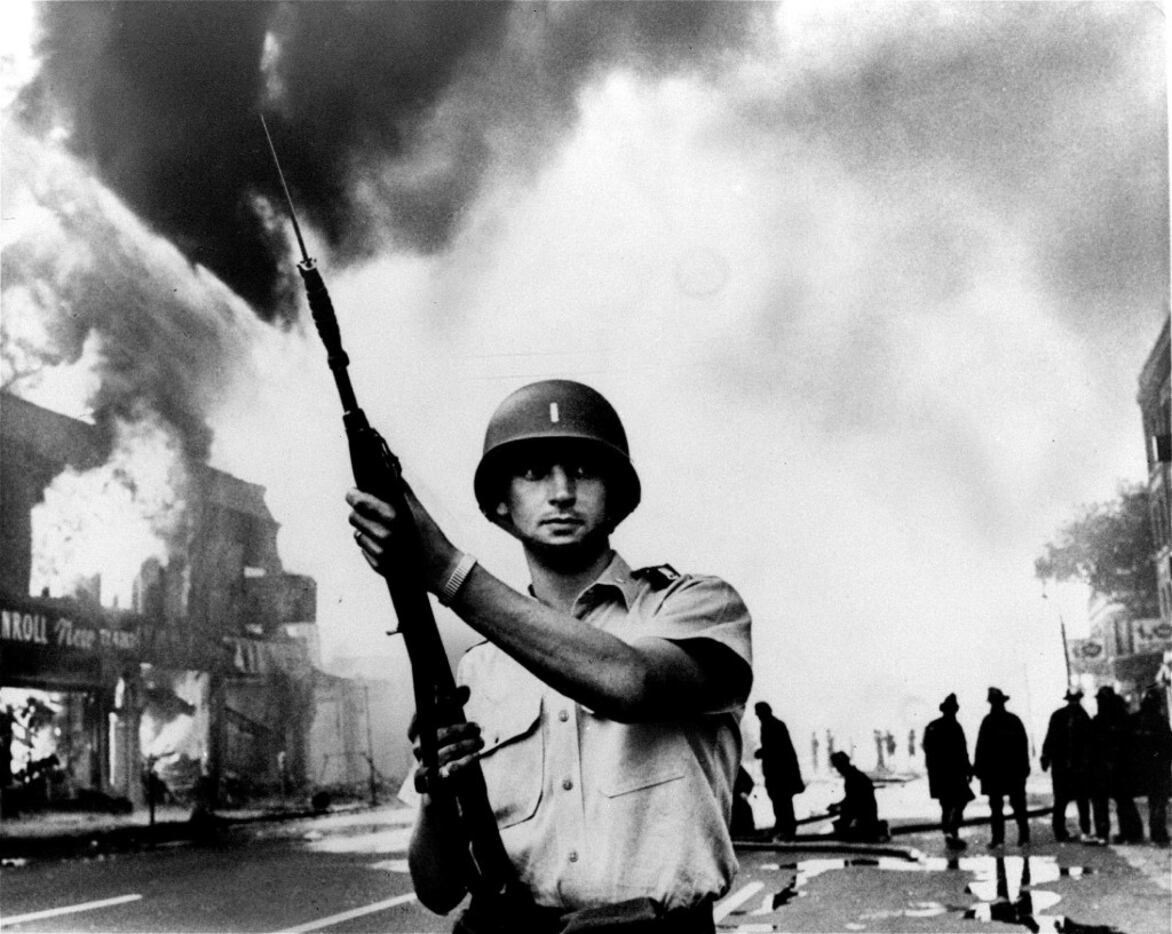 A National Guardsman stands at a Detroit intersection during riots in the city. Detroit...