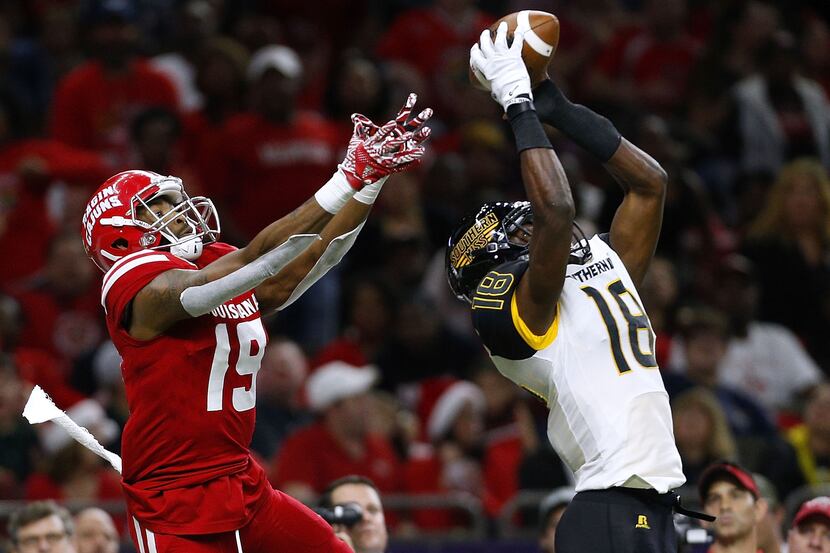 FILE - Tarvarius Moore #18 of the Southern Miss Golden Eagles intercepts the ball over...