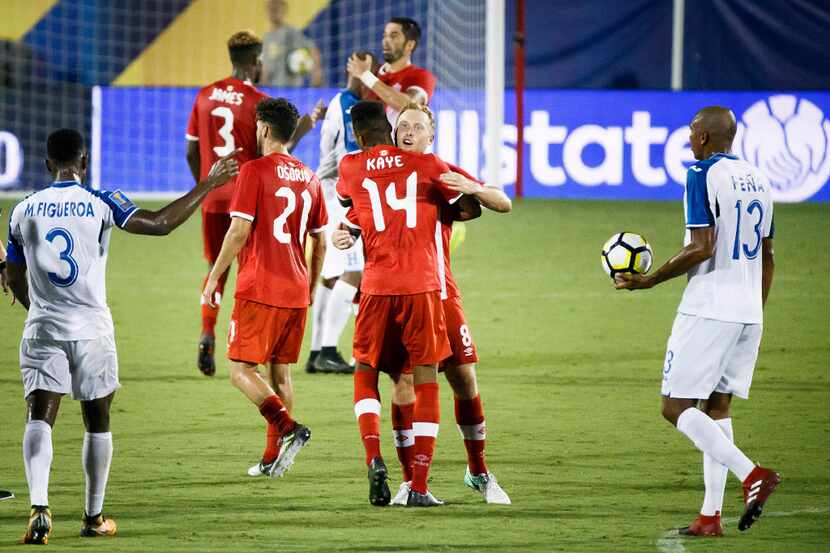 Canada midfielder Samuel Piette, facing camera, celebrates with midfielder Mark-Anthony Kaye...