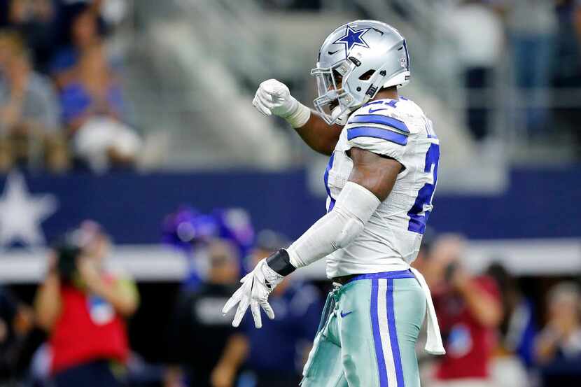 Dallas Cowboys running back Ezekiel Elliott (21) motions the 'feed me' sign after picking up...