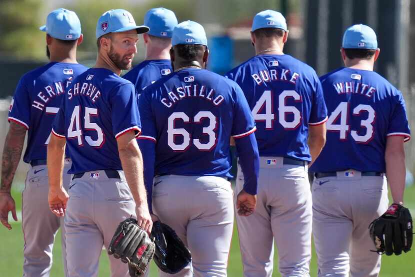 Texas Rangers pitcher Chasen Shreve (45) walks between fields with teammates Jonathan...