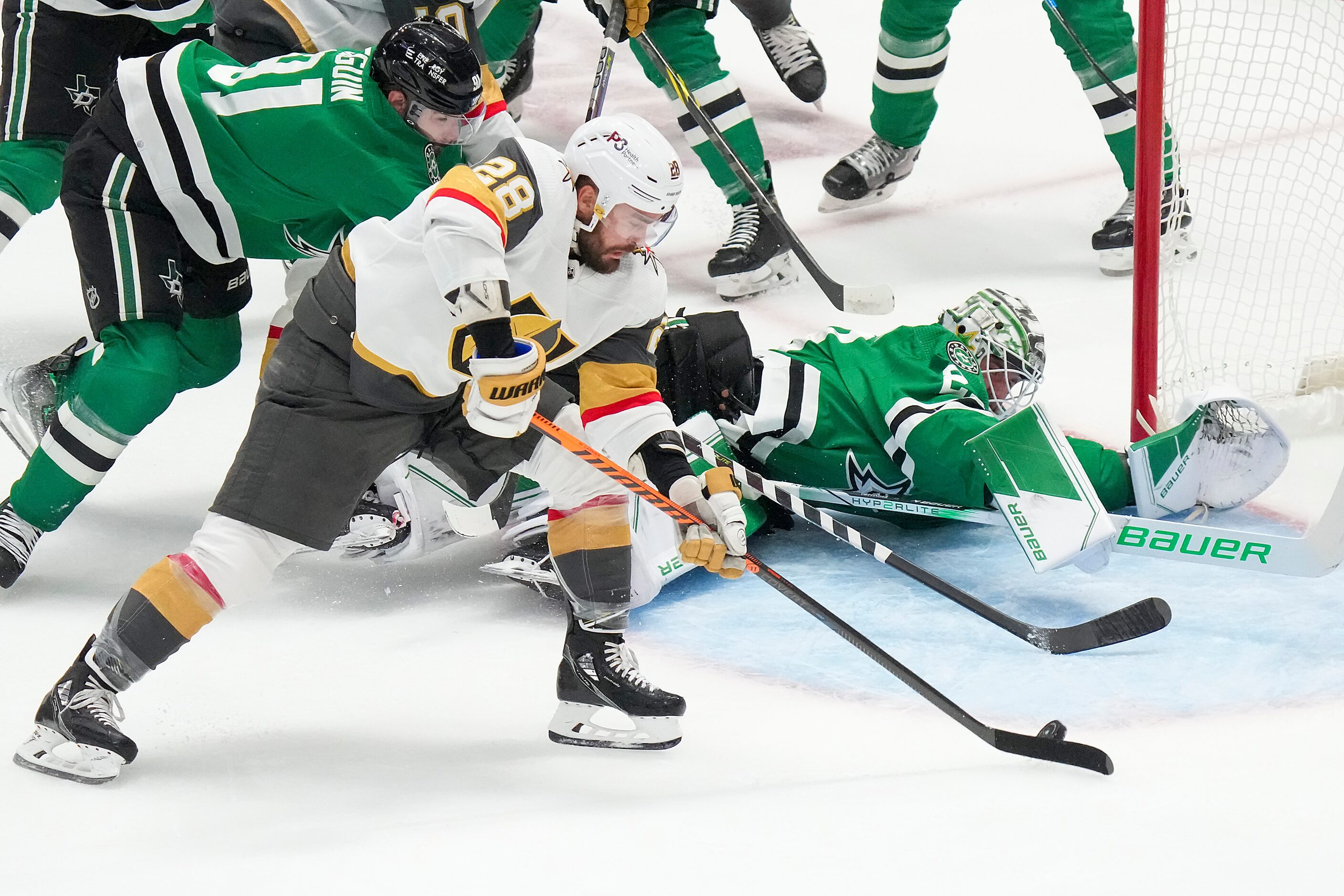 Vegas Golden Knights left wing William Carrier (28) slips the puck past Dallas Stars...