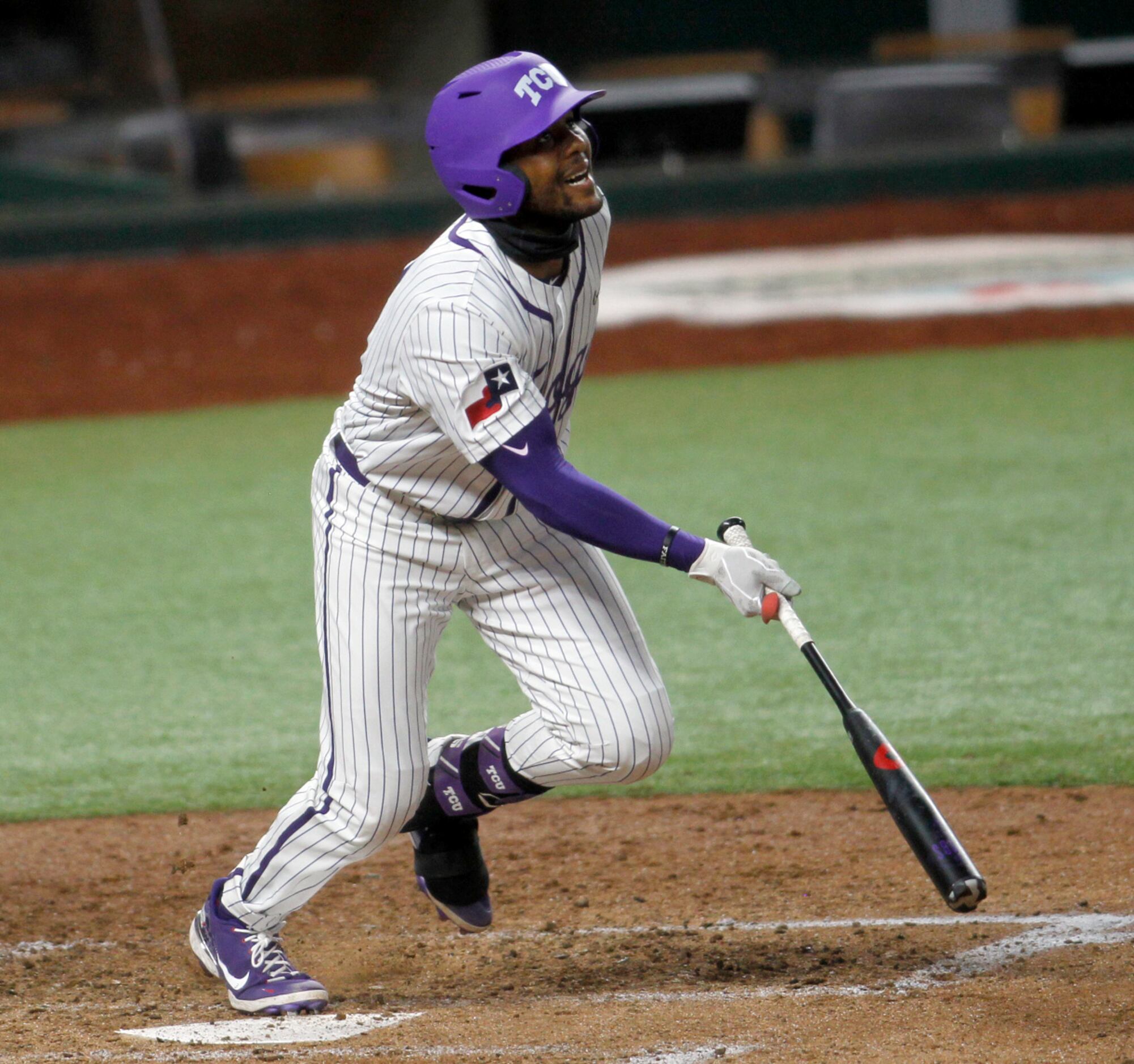TCU infielder Austin Henry (3) watches after driving a ball into right field during the...