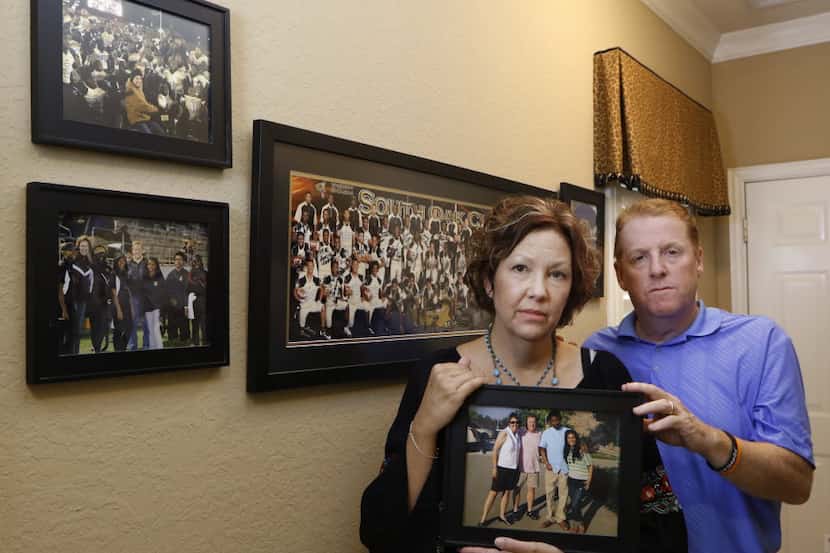 Lisa and Dave Stephenson hold a photograph from 2014, when they hosted Thomas Johnson and...