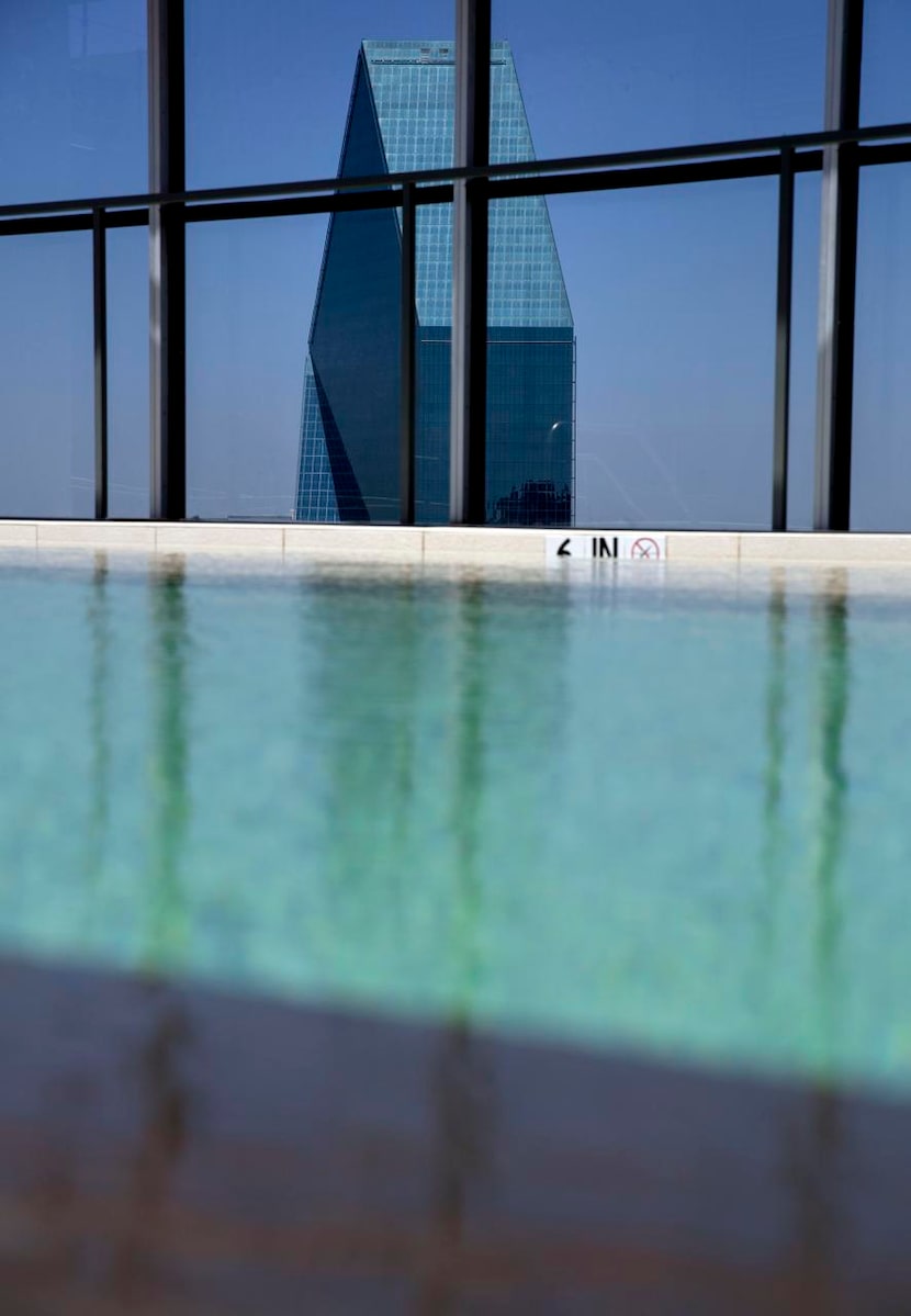 The Fountain Place skyscraper peeks above a swimming pool at the LTV Building Tuesday, July...