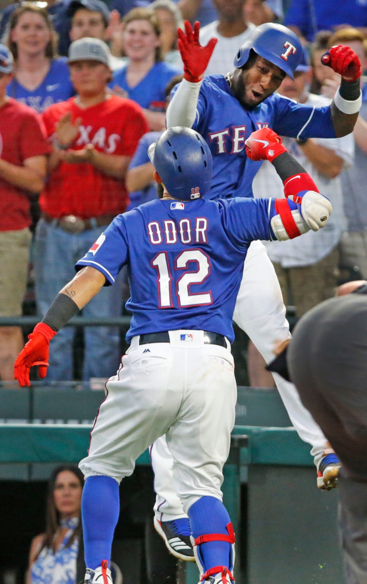 Texas Rangers second baseman Rougned Odor is congratulated teammate Jurickson Profar (19)...