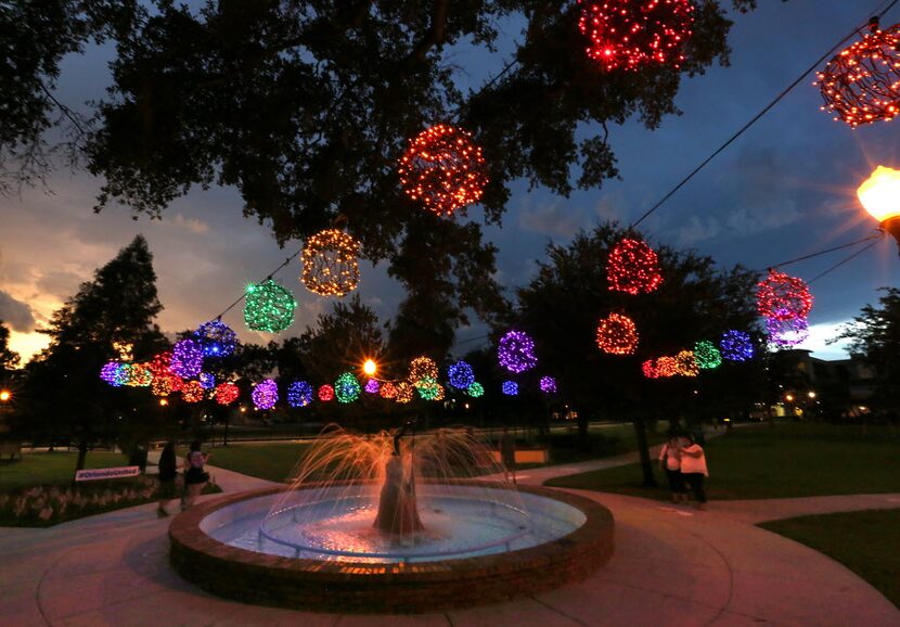 Forty-nine illuminated globes hang over Emily Fountain during the #OrlandoUnited Winter Park...