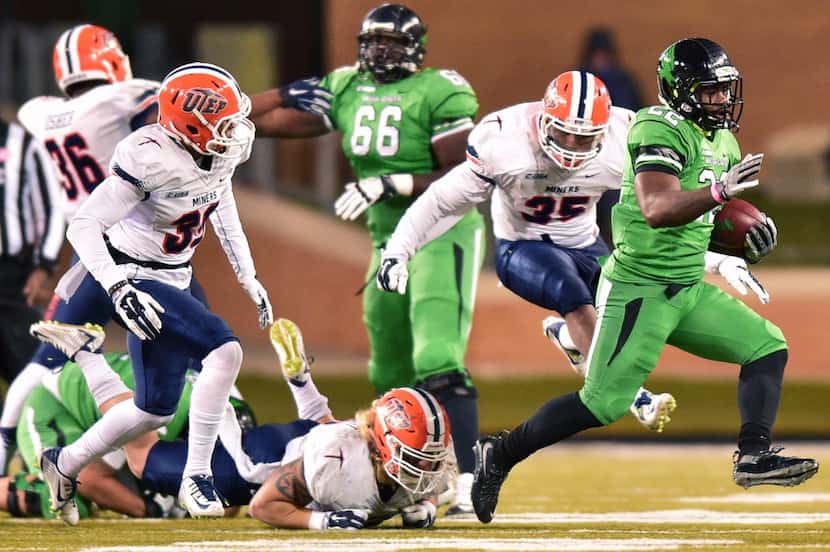 North Texas senior running back Antoinne Jimmerson (22) slips away from a group of Texas-El...