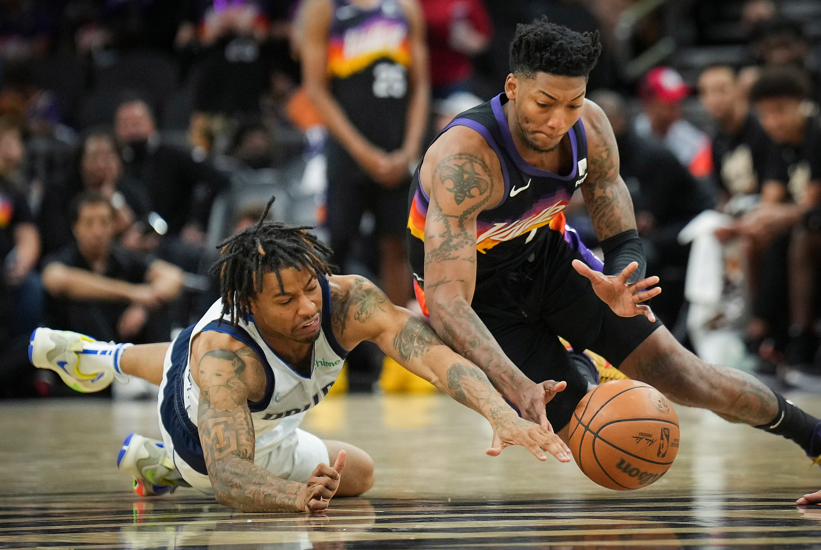 Dallas Mavericks guard Trey Burke (3) dives for a loose ball against Phoenix Suns guard...