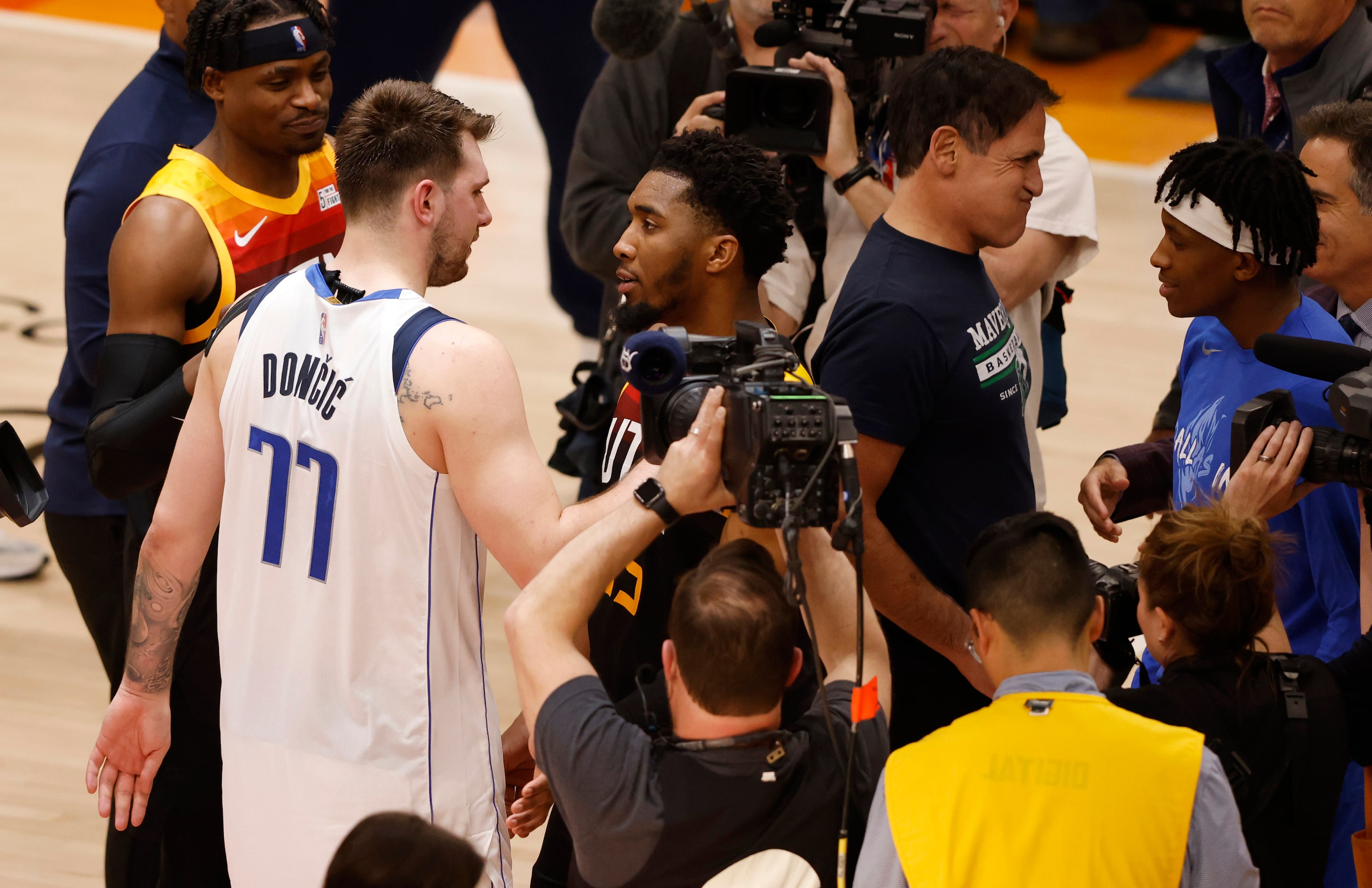 Dallas Mavericks guard Luka Doncic (77) and Utah Jazz guard Donovan Mitchell (45) talk after...