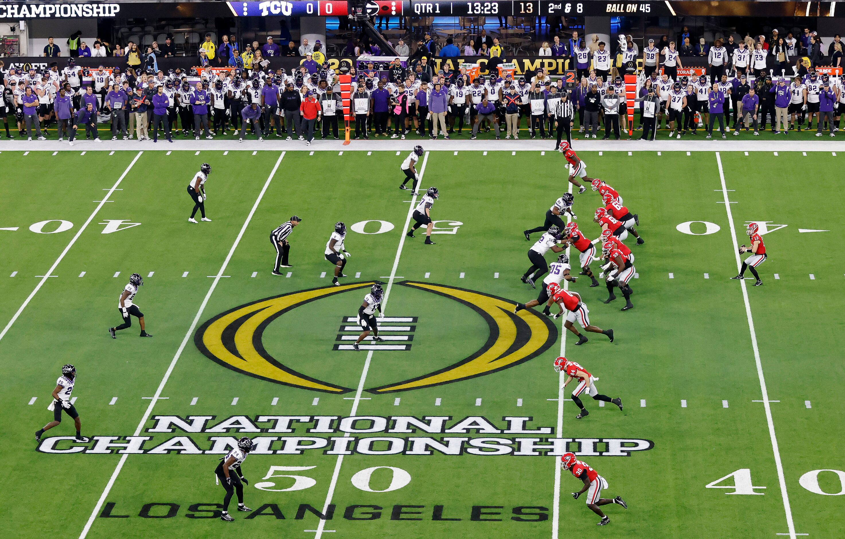 Georgia Bulldogs quarterback Stetson Bennett (13) takes a first quarter snap at midfield...