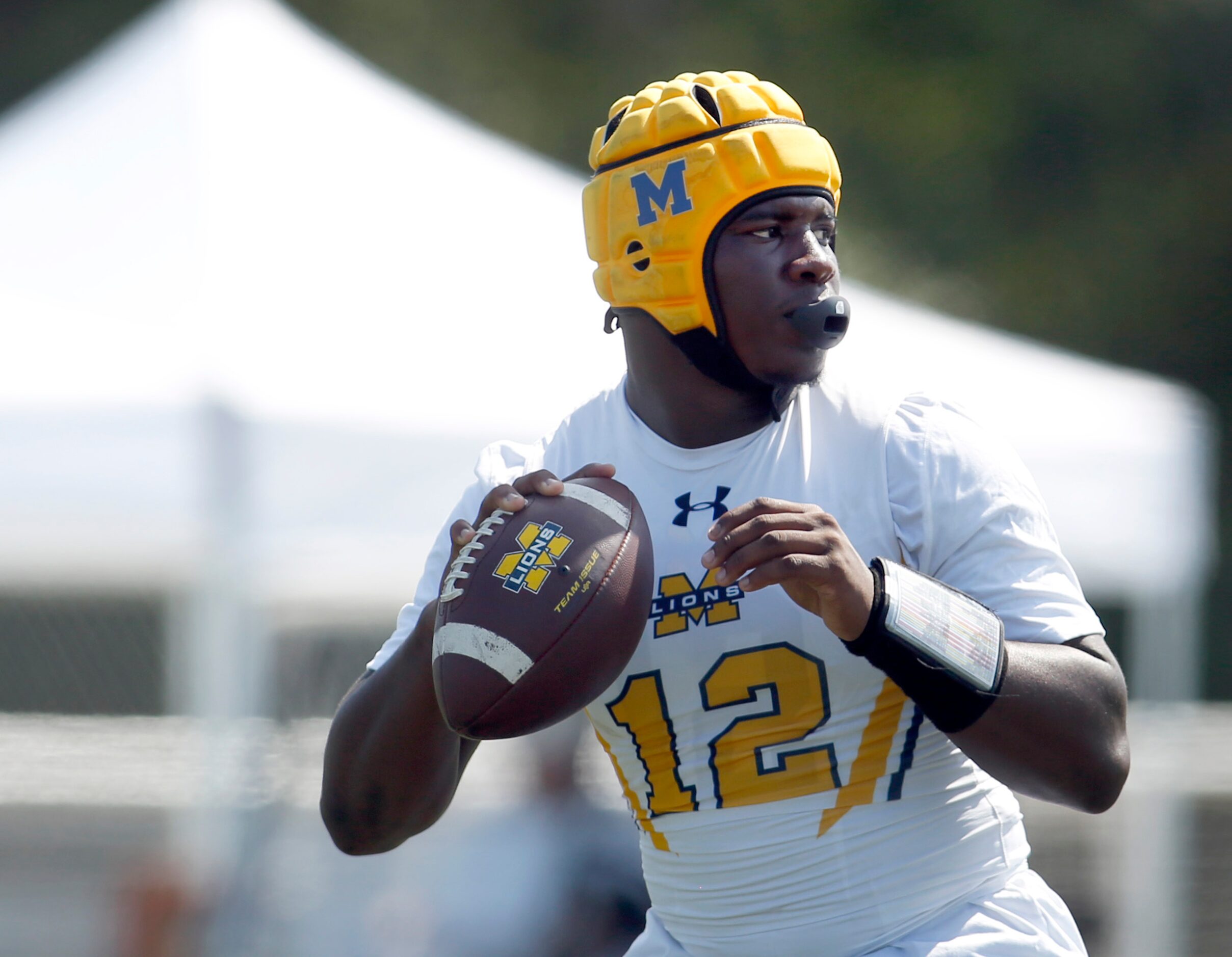 McKinney Lions quarterback Keldric Luster (7) prepares to launch a pass downfield in their...