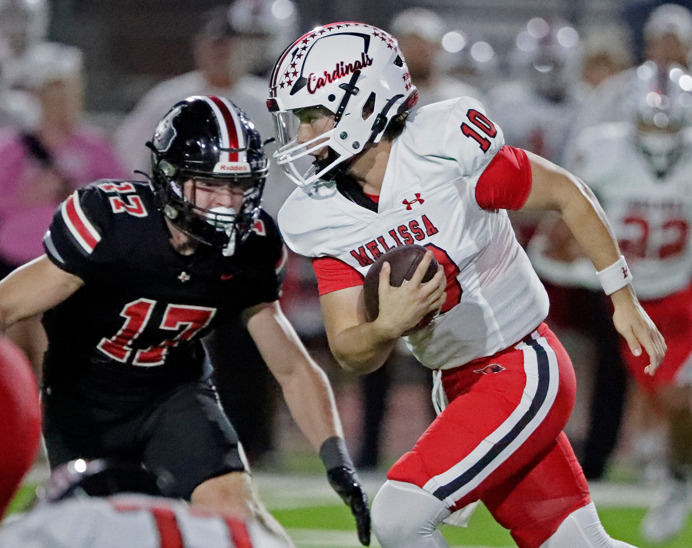 Melissa High School quarterback Noah Schuback (10) runs with the football during the first...