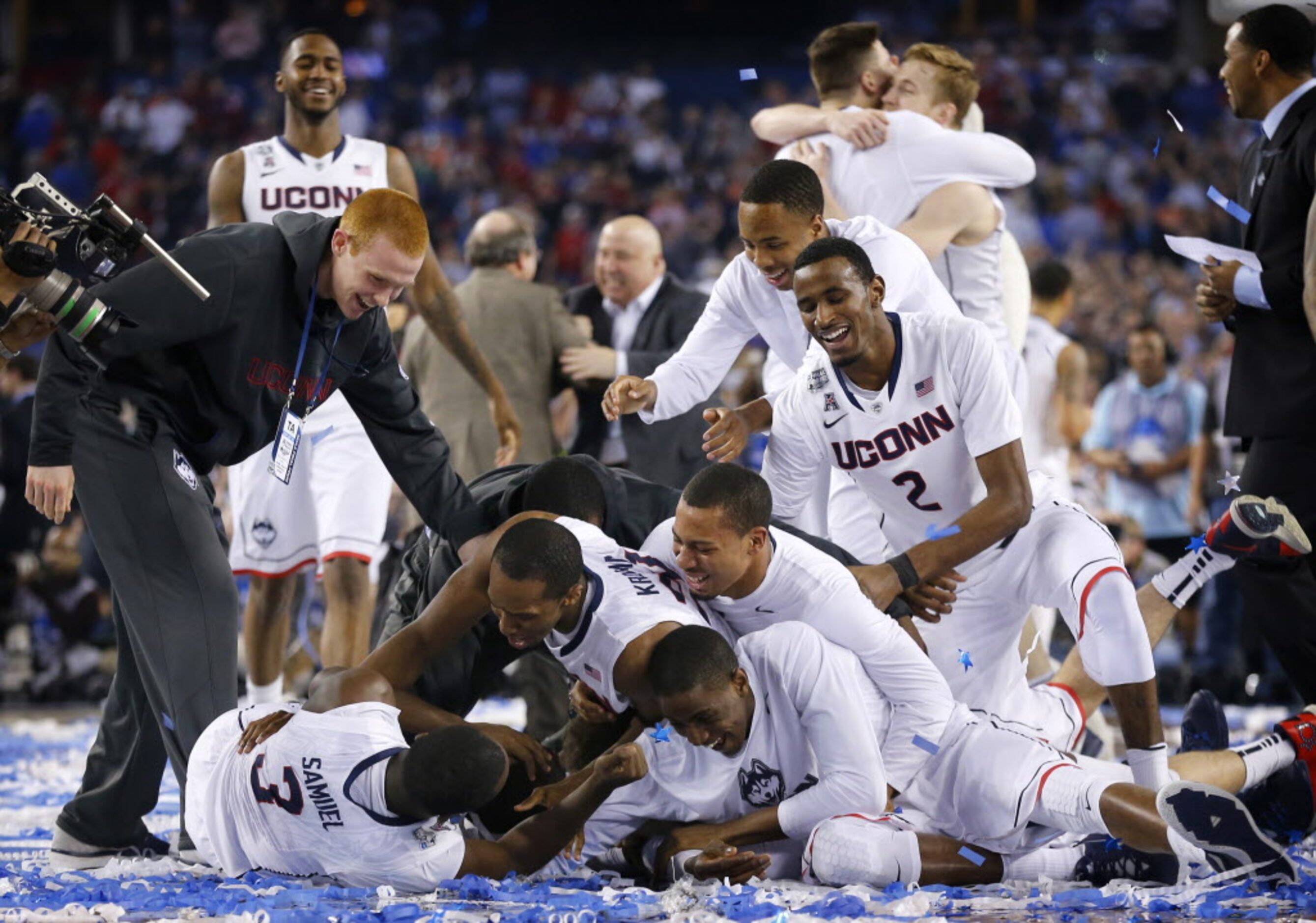 The Connecticut Huskies players pile on Connecticut Huskies center Amida Brimah (35) who was...