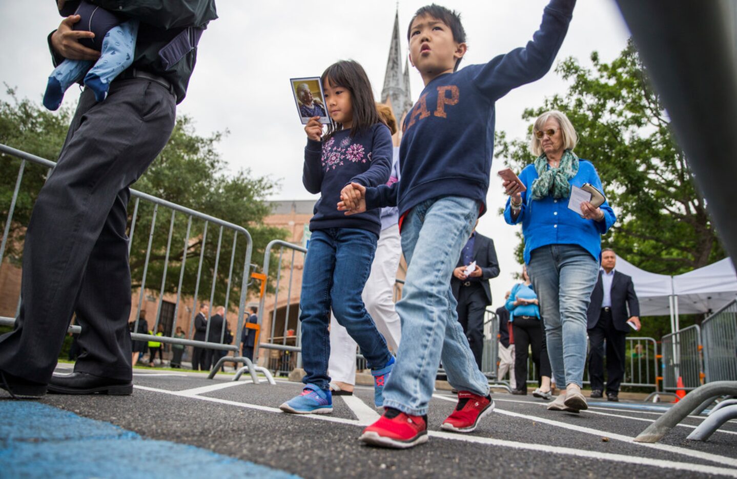 Children look at the program after they and other guests viewed the casket of former first...