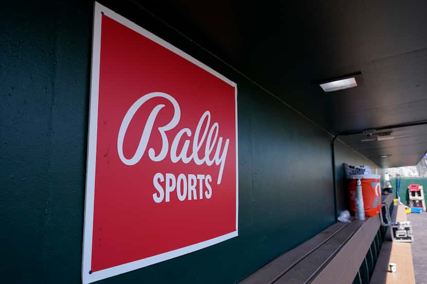 A Bally Sports logo is shown in the dugout during a spring training baseball game at Roger...