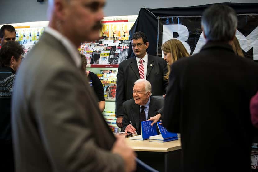 Former President Jimmy Carter signs copies of his book, “A Call to Action,” which focuses on...