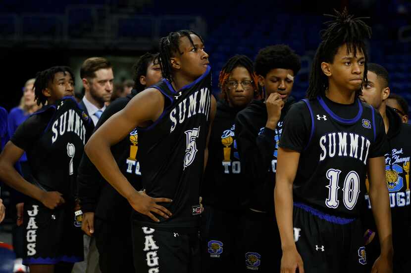 Mansfield Summit's David Terrell (5) and the rest of the team walk off the court after...